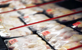 Packaged chicken legs in store refrigerator