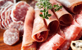 Cold cuts: charcuterie assortment on wooden board