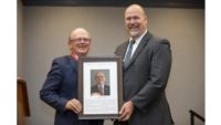 Chris Salm receives his 2022 Wisconsin Meat Industry Hall of Fame induction plaque from Randy Romanski