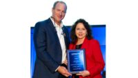 Marla Robison from Aviagen accepting the long-time exhibitor plaque from Mikell Fries (left), USPOULTRY chair and Claxton Poultry Farms.