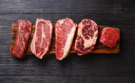 Variety of Raw Black Angus Prime meat steaks Machete, Blade on bone, Striploin, Rib eye, Tenderloin fillet mignon on wooden board copy space