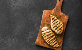 Grilled chicken breast, fillet, steak on wooden board