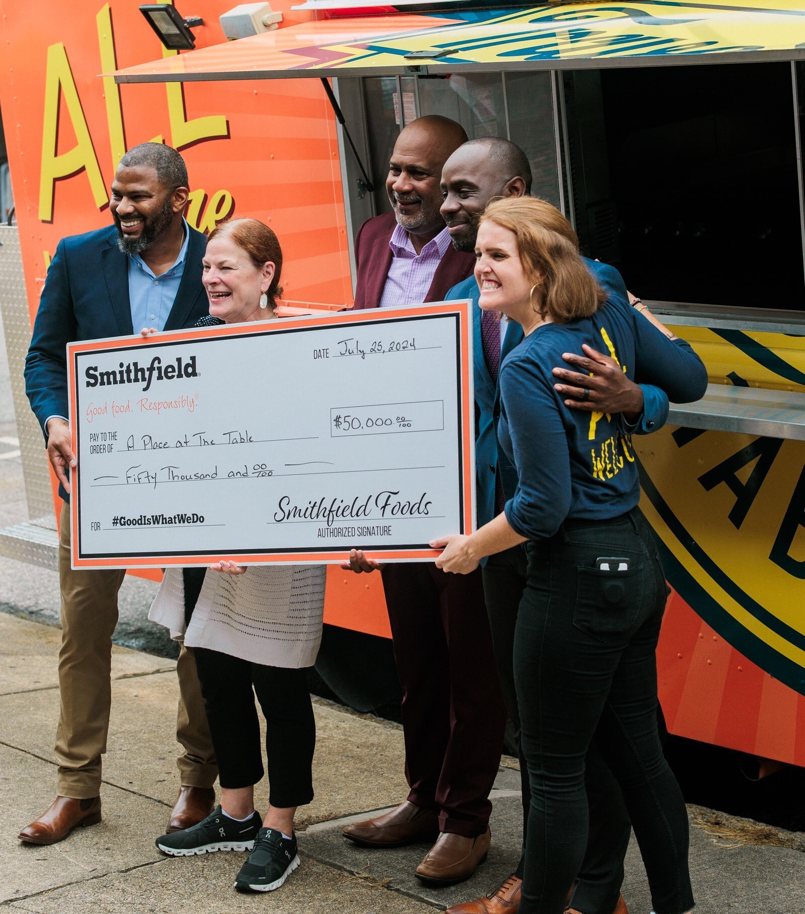 Smithfield presents donation check to A Place at the Table