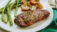 Ribeye plated with potatoes, asparagus