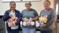 Smithfield Foods employees pack donated food items into boxes for the Laverne Food Pantry in Laverne, Okla.