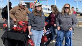 Smithfield Foods employees distribute free hams