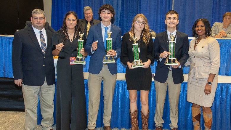 The top team overall, Texas, coached by Jeremy Lee, pictured with Barbara Jenkins. 