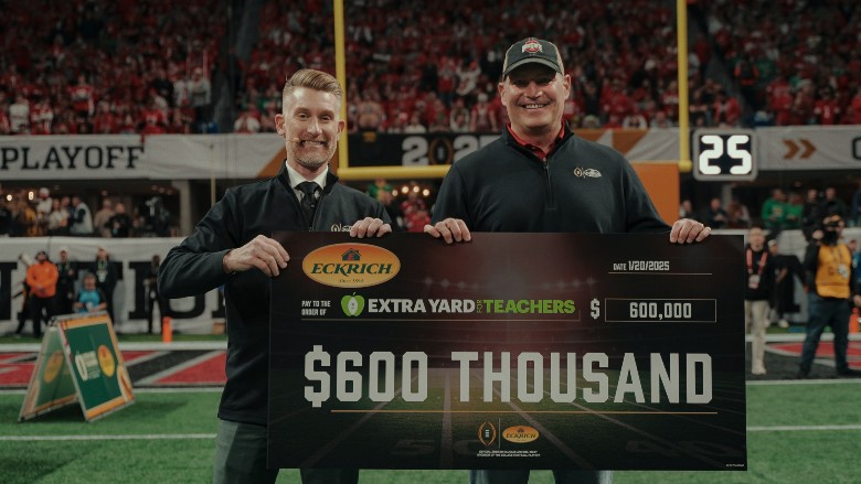 ESPN’s Marty Smith and Smithfield's Steve France present the $600,000 check