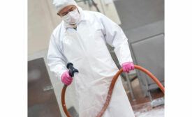 Sanitation Worker with Cleaning Hose